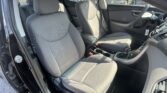 Front interior of a car with gray fabric seats, center console, and steering wheel visible.