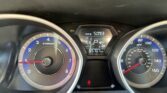 Driver's view of the instrument cluster: left tachometer, right speedometer, center digital display shows Trip A 509.3 and odometer 65,707 miles with a red warning light on bottom.