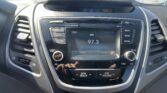 Center console car stereo with FM radio display showing 97.3 and outside temp 47°F; surrounding buttons for Radio, Media, Phone and Mute/Scan.
