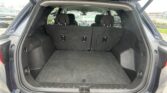 Open SUV trunk showing a spacious cargo area with the rear seats folded up and no cargo inside, view from the tailgate.