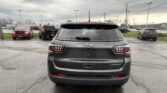 Rear view of a gray Jeep SUV in a parking lot under a cloudy sky; other cars are parked nearby and power lines are overhead.", "Dark gray Jeep SUV with SPORT badge, center of frame, surrounded by red and black vehicles in a lot on an overcast day.", "Rear of a Jeep Grand Cherokee-style SUV, showing taillights and rear window wiper, in a multi-car parking lot with a cloudy sky.", "Parking lot scene with several vehicles; main focus is the back of a gray Jeep SUV.", "Overcast day, center of image is a gray Jeep SUV’s rear end, with other cars and power lines in the background."]} }```Oops, there is an extra quote and formatting issue. Let's correct. I'll provide clean JSON.Oops. Provide corrected.`````````````````````````````თბილის?''` (Let's fix). I'll deliver proper JSON:```json{