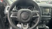 Top-down view of the Jeep steering wheel with the instrument panel behind it in view outside the windshield.
