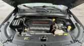 Open-hood view of a car engine bay, with the 2.4L Multiair badge on the engine cover visible at center front.