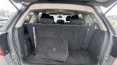 Open SUV rear hatch showing folded third-row seats and empty cargo area