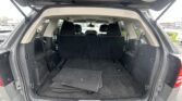 Open SUV hatch showing spacious cargo area with folded floor mats and rear seats upright in black interior privacy.