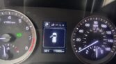 Car dashboard: speedometer up to 140 mph on right, tachometer to 7k rpm on left, central display shows parked with car icon and open door warning, odometer 115,955 mi, temp 56°F, gear in P, Eco indicator on