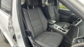 Open car door showing black fabric front seats and center console in a modern SUV interior