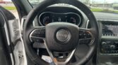 Steering wheel of a Jeep with a digital dashboard and center console in view from the driver’s seat position