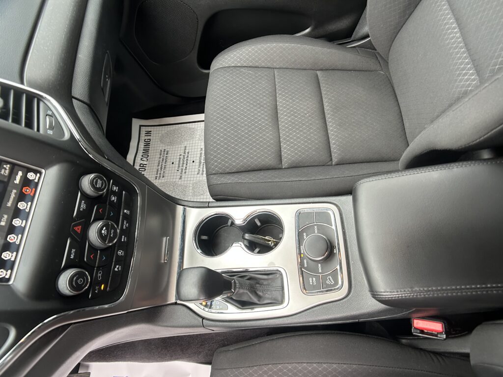 Grey fabric car seat and center console with cup holder visible