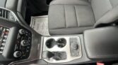 Grey fabric car seat and center console with cup holder visible