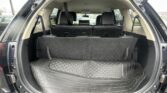 Open SUV cargo area with rear seats upright and a rugged rubber cargo mat visible in the trunk.
