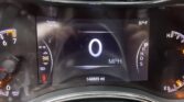 Center digital cluster shows 0 mph, range 144 miles, outside temp 57°F, odometer 148,665 miles, gear in Park (P).