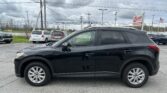 Black SUV parked in a lot with a cloudy sky and an EZ Loan Auto Sales sign in the background.