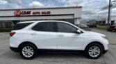 White SUV parked in front of E-Z Loan Auto Sales dealership on a cloudy day