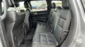 Black leather rear seats in a SUV interior with headrests and red stitching visible on the seams