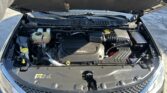 Open car hood showing engine bay with 3.6L engine cover and front grille visible.