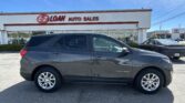 Gray Chevrolet Equinox in the foreground outside an E-Z LOAN Auto Sales storefront on a sunny day, with blue sky and other cars nearby.