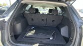Open SUV cargo area with back seats folded for extra storage, and floor mats inside.