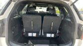 SUV with rear hatch open, showing two rows of seats and a spacious cargo area behind them
