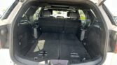 Open SUV rear showing a large, flat cargo area with seats folded down for extra storage.