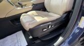 Beige leather car interior with the front seat, center console, and gear shifter visible.