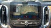 In-dash rearview camera display showing parking guidelines (orange lines) to assist backing up.