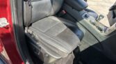 Front interior showing black leather seats, center console, and gear shifter in a red SUV.