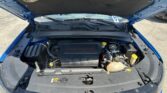 Open car hood showing engine bay with a 2.4L MultiAir engine cover in a blue vehicle