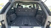 Open SUV cargo area with rear seats upright and spacious trunk space visible