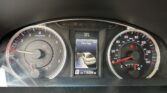 Car dashboard instrument cluster showing speedometer and tachometer with a central display reading 'Door Ajar' and vehicle icons; outside temperature 57°F, odometer 116,504 miles.