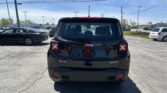 Rear view of a black Jeep SUV in a parking lot with other cars and power lines above on a sunny day