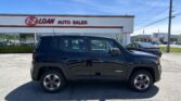 Front view of a black Jeep Renegade parked in a car lot in front of the E-Z Loan Auto Sales storefront under a blue sky.