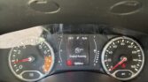 Dashboard in a car: tachometer left, speedometer right, central display shows 'Engine Running' and mileage 92,329 miles; windshield has raindrops nearby.