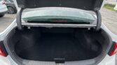 Open trunk of a white Hyundai Sonata, showing a spacious black cargo area and rear window.