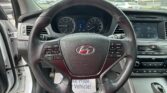 Front dashboard view from the driver seat showing the steering wheel, instrument cluster, and center touchscreen. (Informative image)