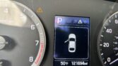Orange warning triangle on the car dashboard near the central display.