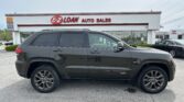 Black Jeep Grand Cherokee SUV parked in a dealership lot with the E-Z LOAN AUTO SALES building in the background.