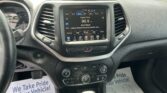 Infotainment touchscreen in a car showing FM radio 96.9 with 'Classic Rock' playing, plus surrounding climate controls and vents.