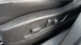 Front seat base in black leather with side adjustment levers visible on the lower panel.