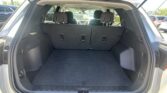 Open SUV trunk showing spacious cargo area with rear seats upright and no items inside.