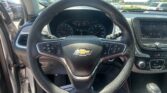 Front interior shot of a Chevrolet SUV with a steering wheel, instrument cluster, and touchscreen display visible through the windshield.
