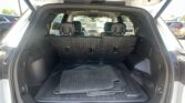 Open SUV trunk showing stacked rubber floor mats in the cargo area, labeled Equinox, with rear seats visible ahead.