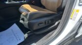 Front passenger seat in a car with tan leather upholstery and center console visible.