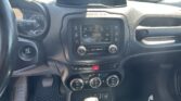 Car interior view of the center console: touchscreen infotainment system, air vents, and climate controls visible from the driver’s seat side edge.