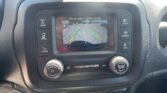 In-car infotainment screen showing rearview camera with parking guide lines (green, yellow, red) as the car backs up.