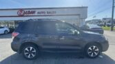 Dark gray SUV in a dealership lot with the E-Z Loan Auto Sales storefront and sign in the background on a sunny day