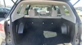 Open SUV hatch revealing spacious cargo area with rear seats upright, ready for loading, in a parking lot.