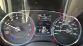 Dashboard instrument cluster with a tachometer on the left, speedometer on the right, and a center display showing Door/Liftgate Open and gear indicator (P).