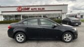 Black sedan in the foreground at an auto dealership, with an EZ LOAN AUTO SALES storefront in view and a Toyota dealership in the background.
