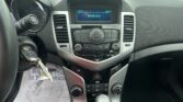 Interior of car dashboard: center console with digital display showing time 3:17, date 05/05/2026, and 64°F outside, plus control buttons nearby.